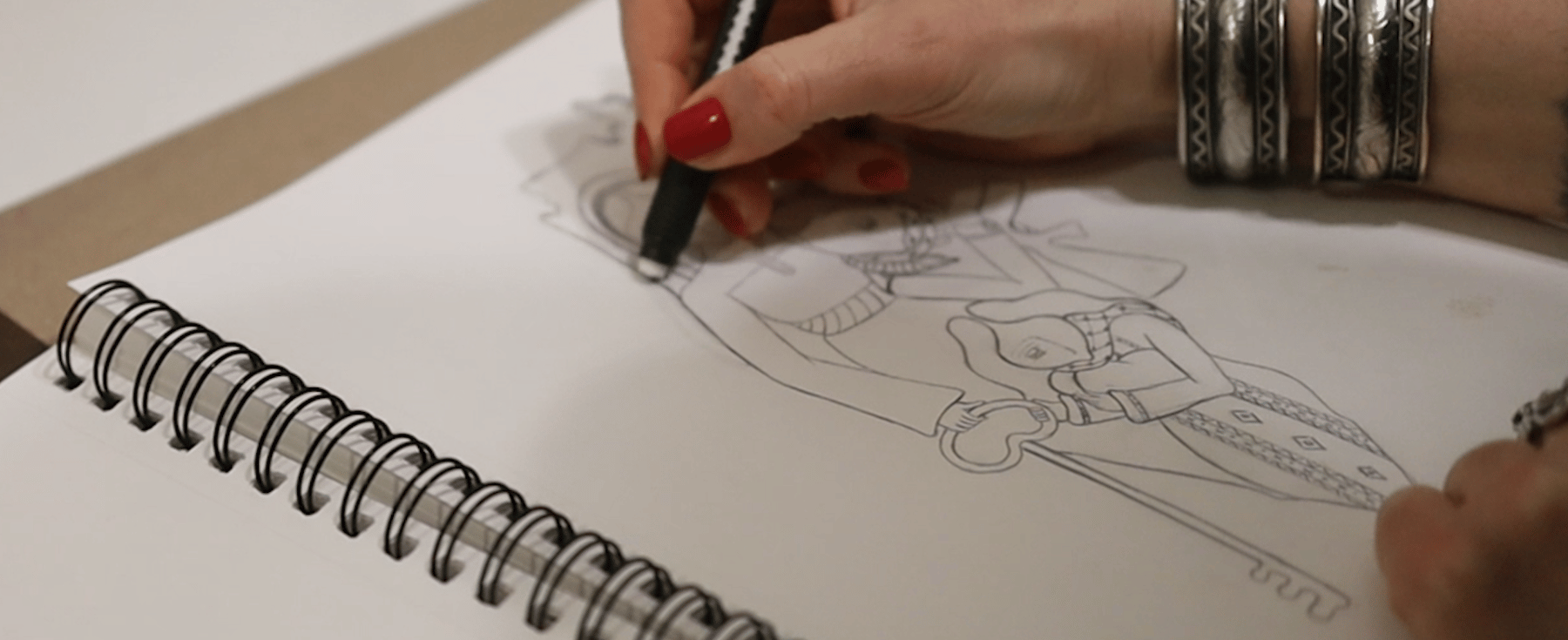 A close look at Mary Hazboun sketching one of her illustrations.